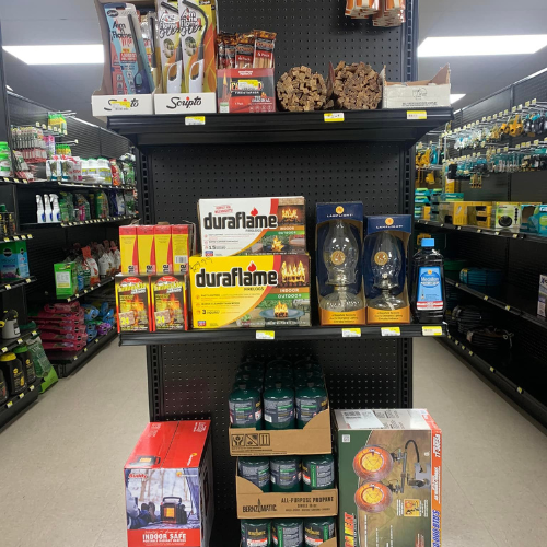 Duraflame supplies and propane tanks on display inside of Blakeney Hardware.