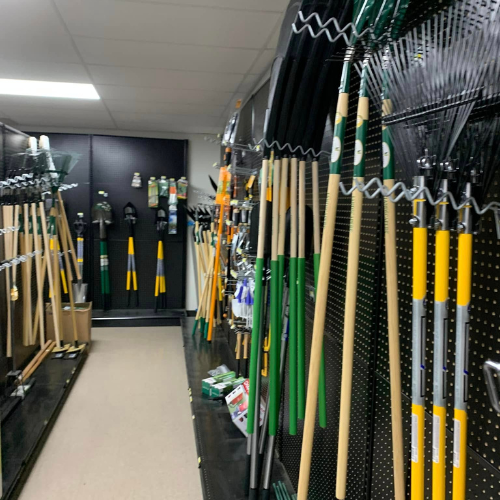 Lawn and garden tools on display inside of Blakeney Hardware.